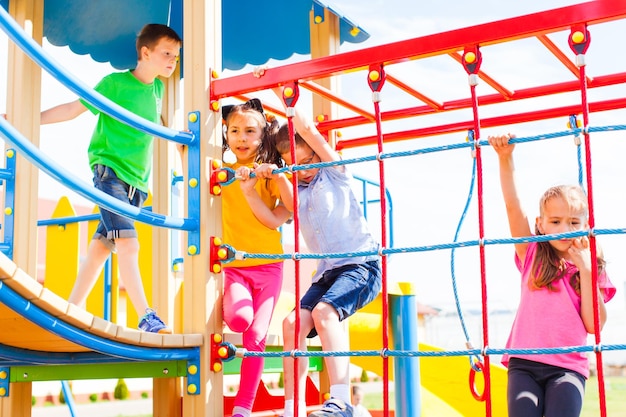 Children climb a rope wall at the colored playground