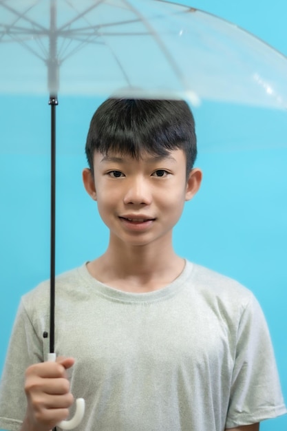 Children close up photo of cute and cheerful people, holding umbrella looking and smile