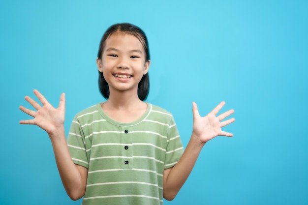 Children close up photo of cute and cheerful people, looking and smile on blue pastel background