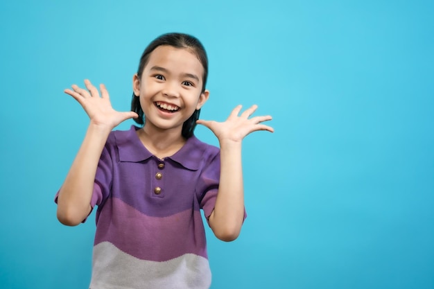 Children close up photo of cute and cheerful people, looking and smile on blue pastel background