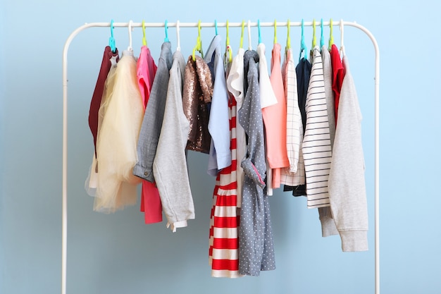 Children clothes on a hanger on a colored background