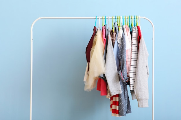 Children clothes on a hanger on a colored background