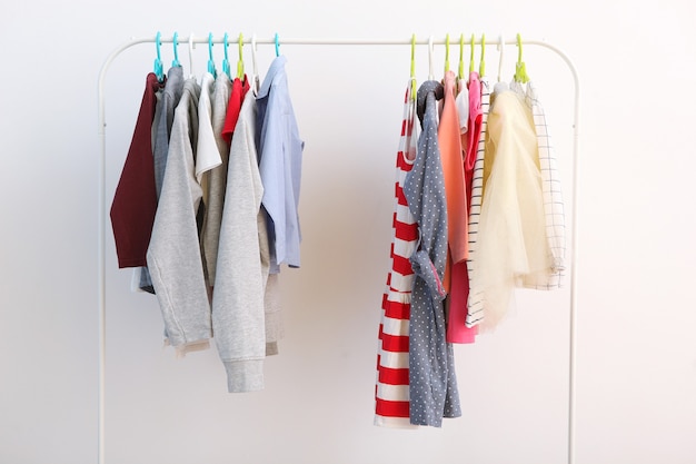 Children clothes on a hanger on a colored background