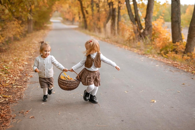 Children collect autumn foliage