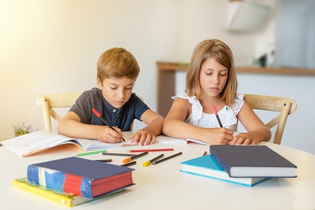 Children concentrating on drawing and studying at home Kids doing homework Back to school