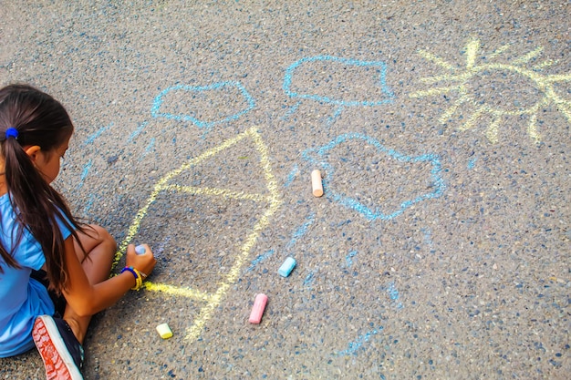 Children draw the Ukrainian flag house on the pavement Selective focus