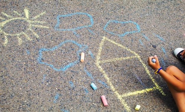 Children draw the Ukrainian flag house on the pavement Selective focus