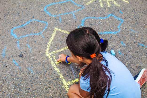 Children draw the Ukrainian flag house on the pavement Selective focus