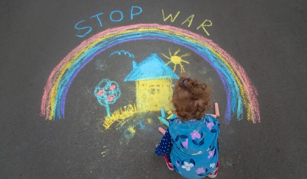 Children draw the Ukrainian flag house on the pavement Selective focus