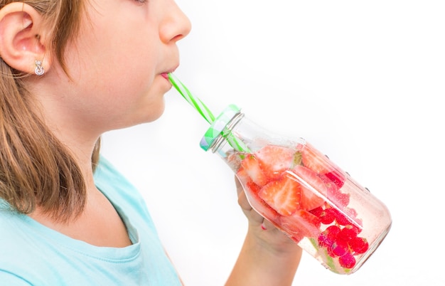 Children drinking fresh water fruit with straw