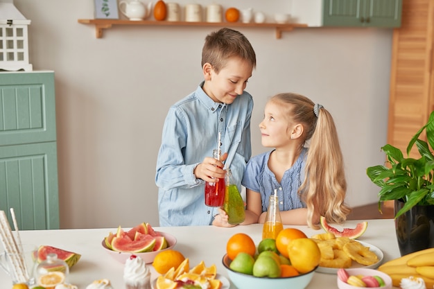 Children drinking juices at the kitchen