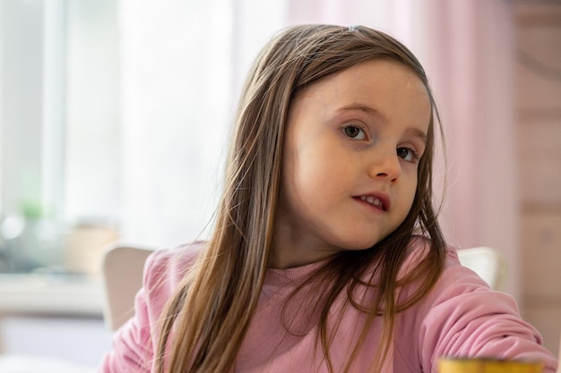 Children emotions. Portrait of surprised pretty girl on natural background