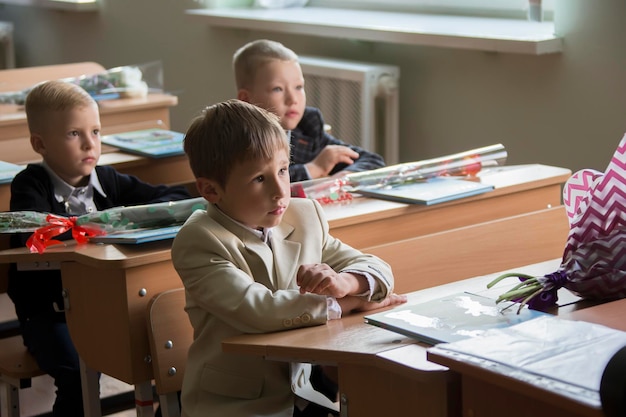 Children firstgraders on the first of September for school desks Primary school pupils