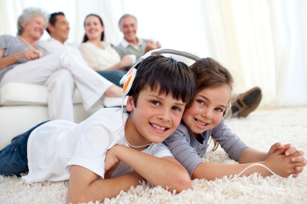 Children on floor listening to the music in living-room