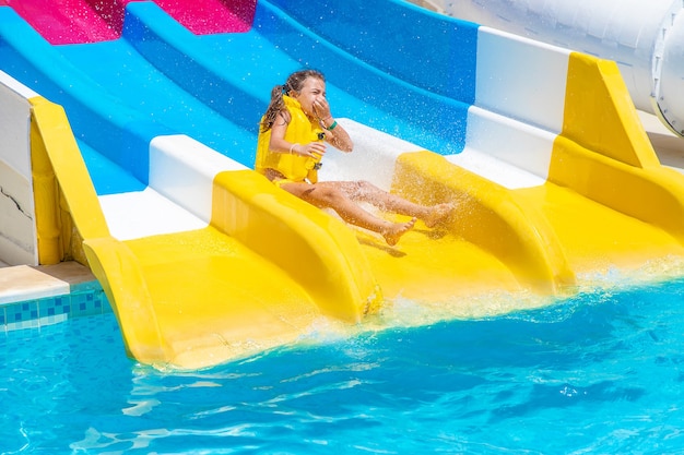 Children gowing down from the slides in a water park