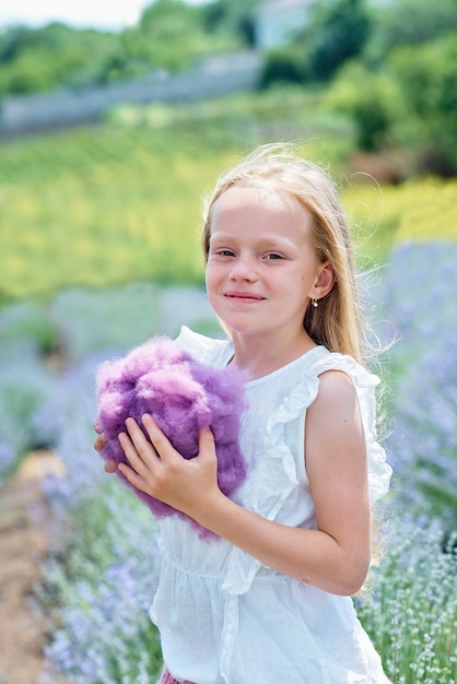 Children in lavender field catching cloud of wool.