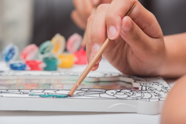 Photo children learn coloring and painting in classroom.