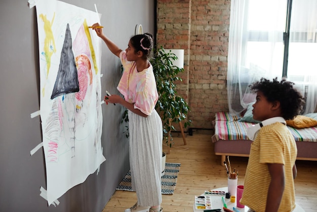 Children painting a picture together