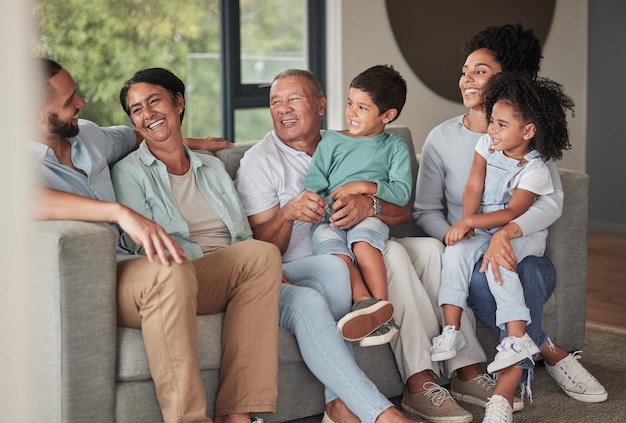 Children parents and happy grandparents on sofa generations of family together in living room Love home and couple with kids grandma and grandpa from Brazil relax and smile on couch in new home