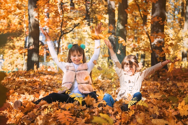 Children in the park with autumn leaves Selective focus