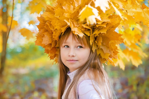 Children in the park with autumn leaves. Selective focus.