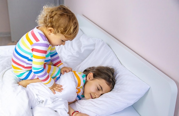 Children play jumping in bed Selective focus