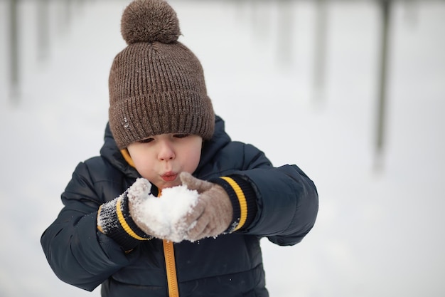 Children play outside in the winter Snow games on street