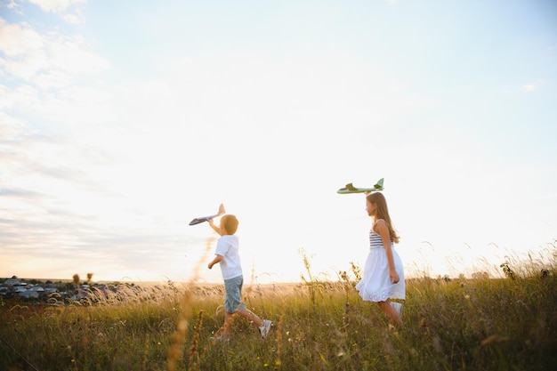 Children play toy airplane concept of happy childhood children dream of flying and becoming a pilot