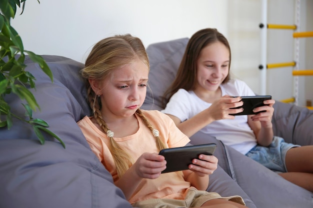 Children play with a mobile phone at home