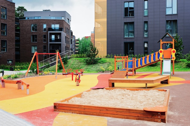 Children playground in European modern complex of apartment residential buildings quarter. With outdoor facilities.