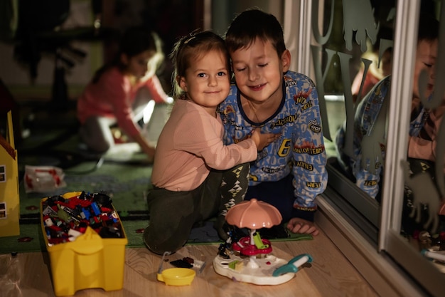 Children playing at home during a blackout using alternative lighting