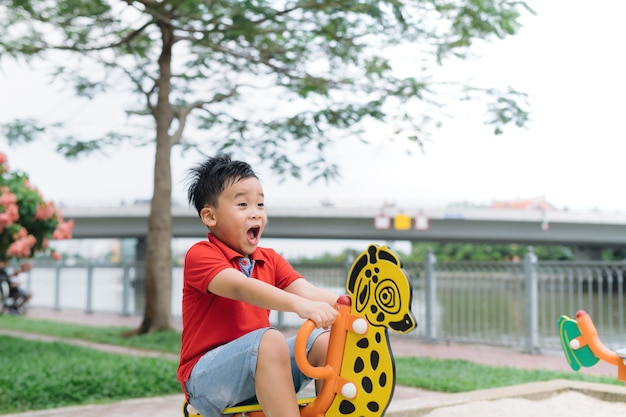 Children playing on playground in summer outdoor park