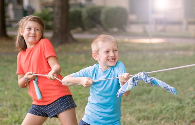 Children playing tug of war at the park