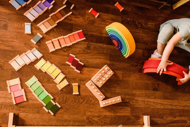 Photo children playing with wooden rainbow waldorf montessori