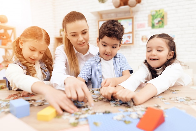 Children put puzzles together with adults.