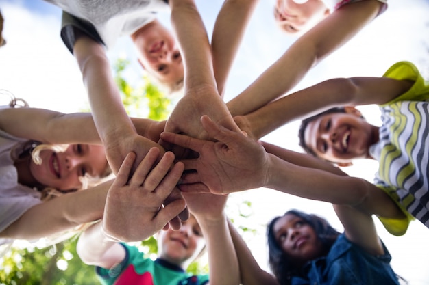 Children putting their hands together