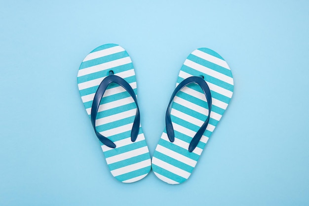 Children's beach flipflops on a blue background