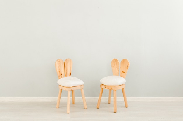 Children's chairs near the wall in Scandinavian style