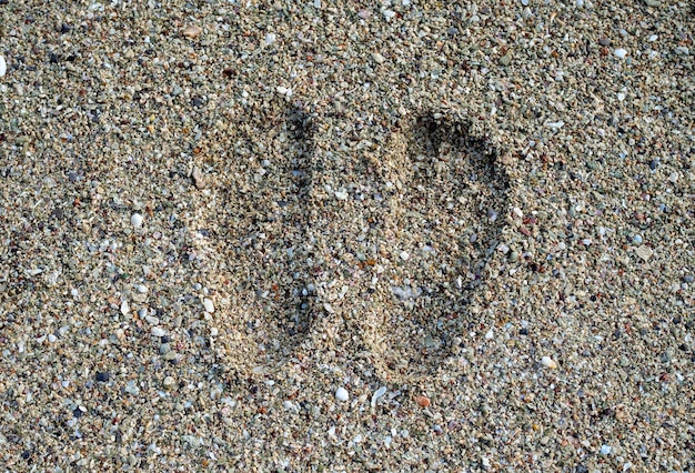 Children's footprints stamped on the sand on the beach