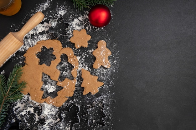 Children's hands make New Year's gingerbread cookies on a wooden table. Making cookies with a cookie cutter. New Year and Christmas concept.