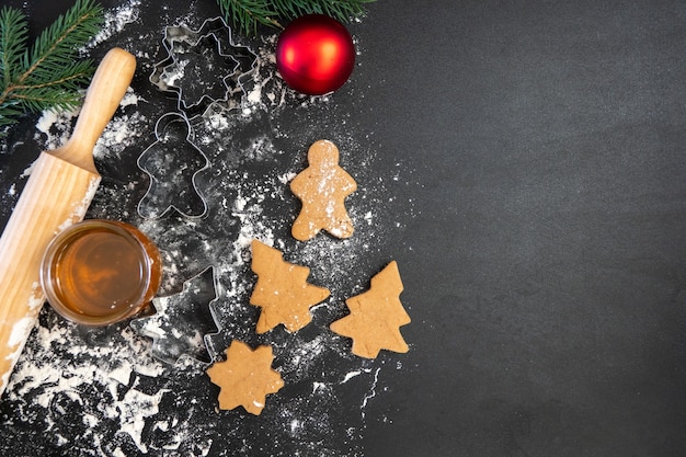 Children's hands make New Year's gingerbread cookies on a wooden table. Making cookies with a cookie cutter. New Year and Christmas concept.