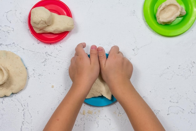 Children's hands sculpt salty dough Development of fine motor skills of the hands Development of children's creativity