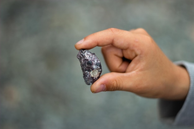 children's hands stones gray background