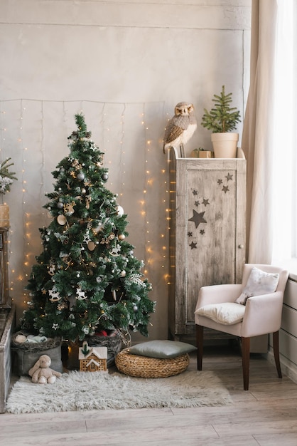 Children's room decorated for Christmas and New Year Christmas tree wardrobe armchair and ottoman