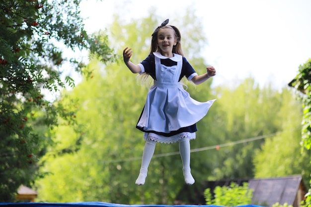 Children in school uniforms walk on the street Children rejoice and have fun at the end of the school year Holidays