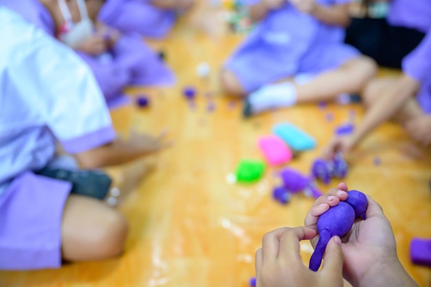 Children sit and make plasticine in the classroom at school Plasticine in a basic art class School Children are skilled in sculpting clay