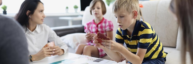 Children spend time with parents mother entertain kids with games on holiday