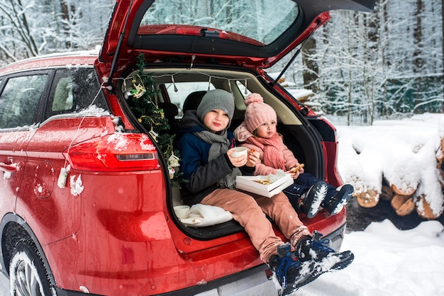 Children in the trunk of a car in winter