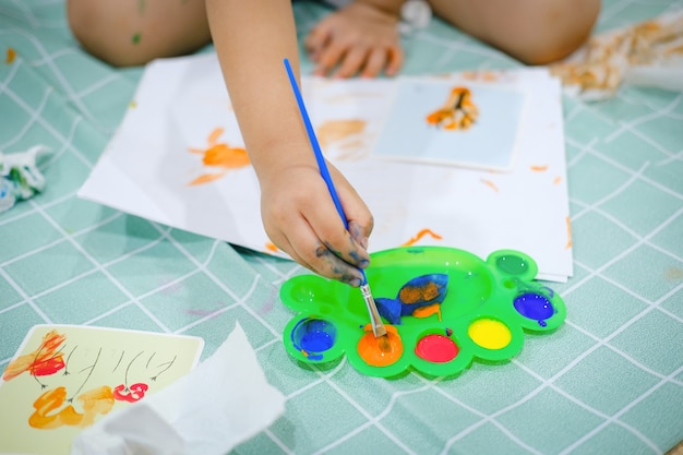 Children use watercolor brushes to create imagination and enhance their learning skills.