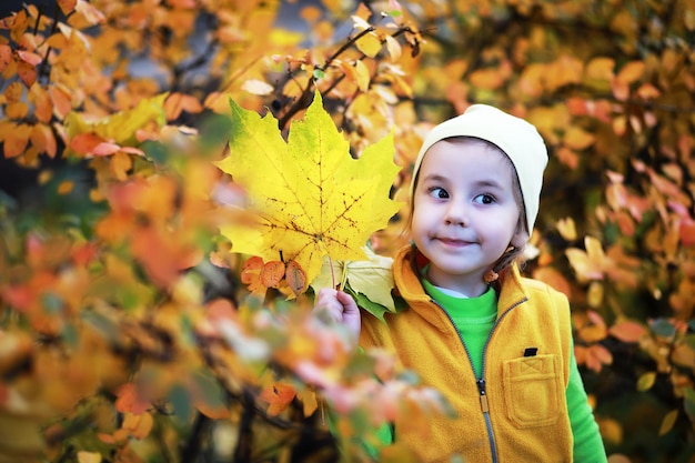 Children walk in the autumn park in the fall